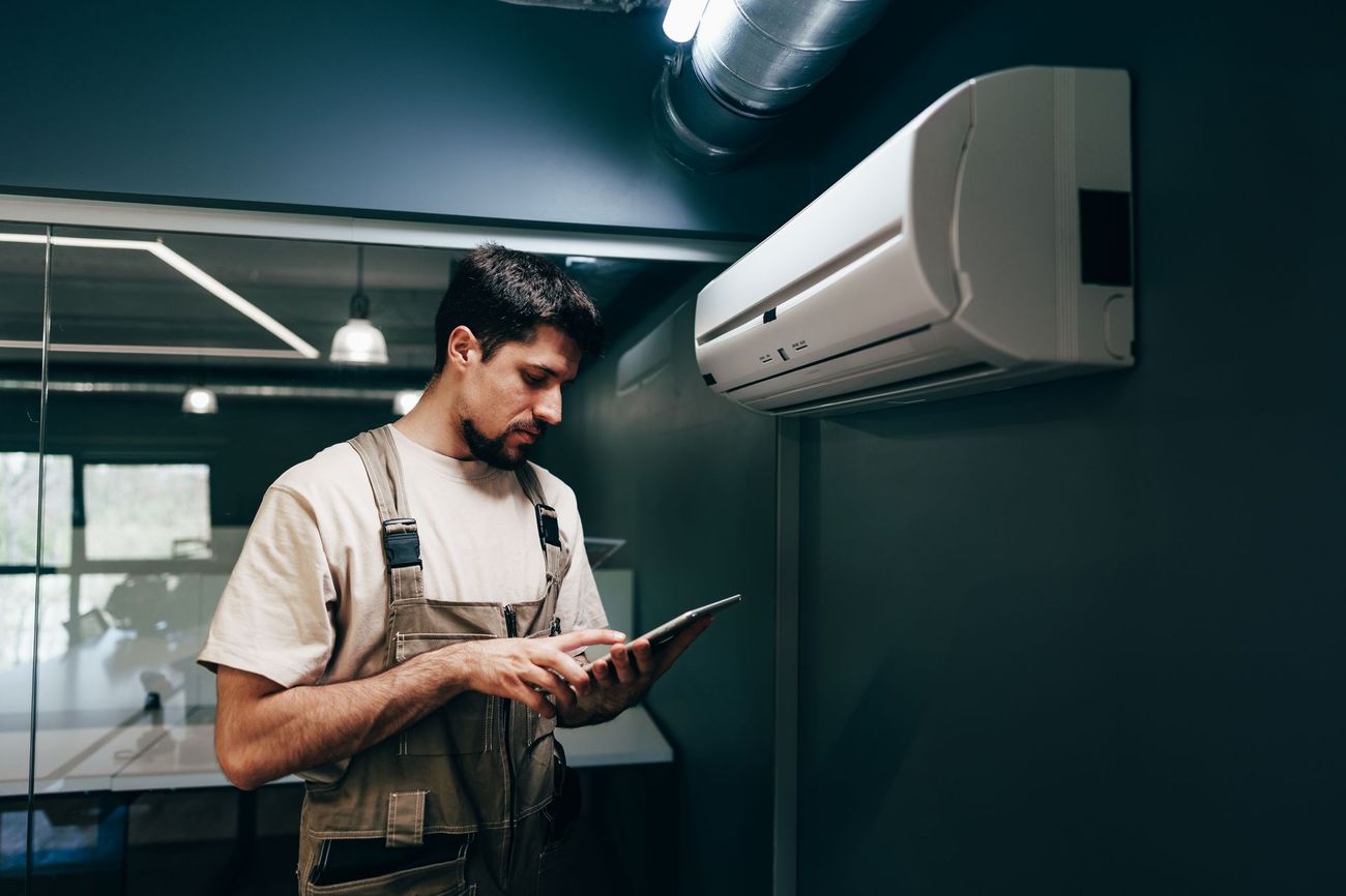 Father & Son technician performing a garage door safety inspection